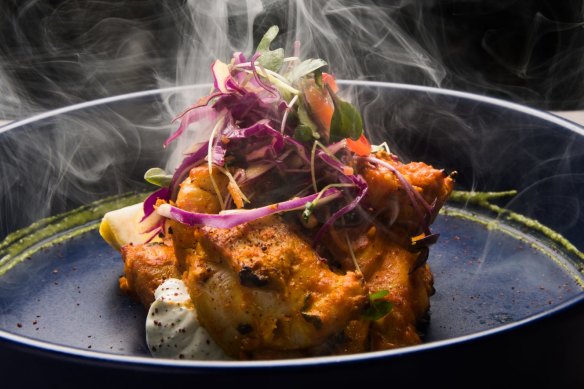 Chicken tikka is presented with a puff of smoke.