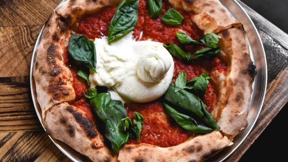Burrata, tomato sugo and fried basil pizza from the wood-fired oven.
