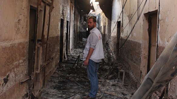 An employee of the Doctors Without Borders in the charred remains of the hospital earlier this month after it was hit by a US airstrike.