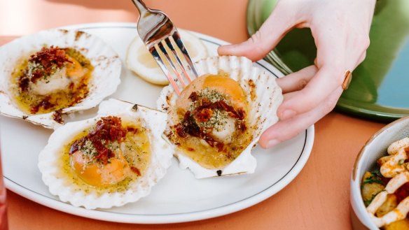 Baked scallops with garlic, jamon and parsley crumb are one of the many seafood-focused plates.