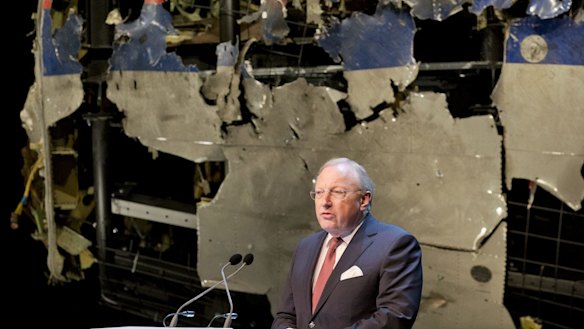 Tjibbe Joustra, head of the Dutch Safety Board, presents the final report into what caused MH17, seen reconstructed at rear, to break up high over Ukraine last year.