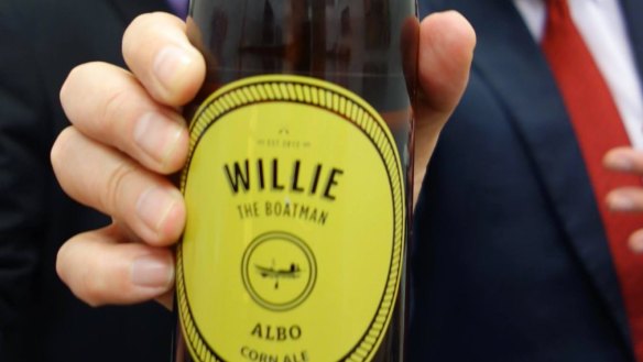 Anthony Albanese holding a bottle of the beer that was named after him.