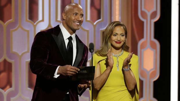 Dwayne Johnson and Jennifer Lopez present an award at the 73rd Annual Golden Globe Awards in January 2016.