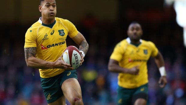 At full flight: Israel Folau leaves the Welsh defence in his wake on Saturday.