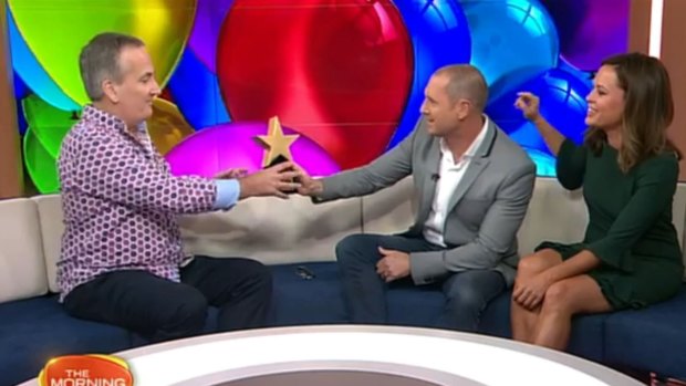 Happy birthday ... Glenn Wheeler receives gifts from good mate Larry Emdur on the Morning Show.