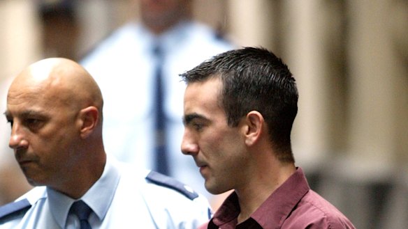 Jason Roberts is led handcuffed to the prison van at the Supreme Court on December 31, 2002.