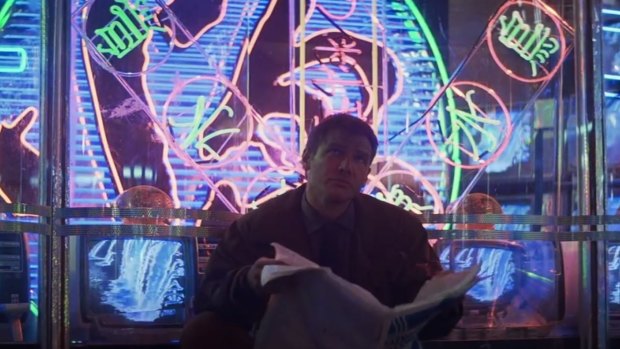 Deckard (Harrison Ford) and newspaper in <i>Blade Runner</i> (1982).