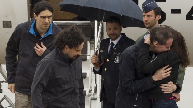 The three freed Spanish journalists - Antonio Pampliega, right, Jose Manuel Lopez, left, and Angel Sastre - arrive at the Torrejon military airbase in Madrid, Spain. 