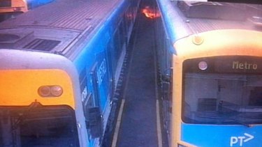 Flames shoot from a train  caused by an electrical fault. The fire did not spread but three trains have been pulled out of service.