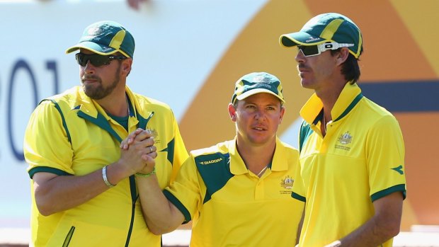 From left: Australian captain Matt Flapper celebrates winning a game with team mates Wayne Ruediger and Nathan Rice of Australia during the Men's Triples at Kelvingrove Lawn Bowls Centre.