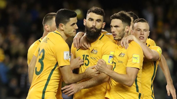 No venue switch: Skipper Mile Jedinak is congratulated by teammates after his penalty against Japan. 

