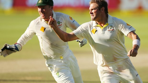 Iconic moment: Ryan Harris celebrates as his double-wicket over clinches the deciding Test in Cape Town in 2014.