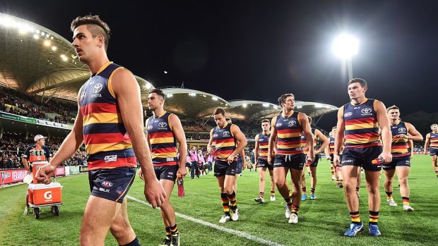 Skipper Taylor Walker leads the Crows from the ground.