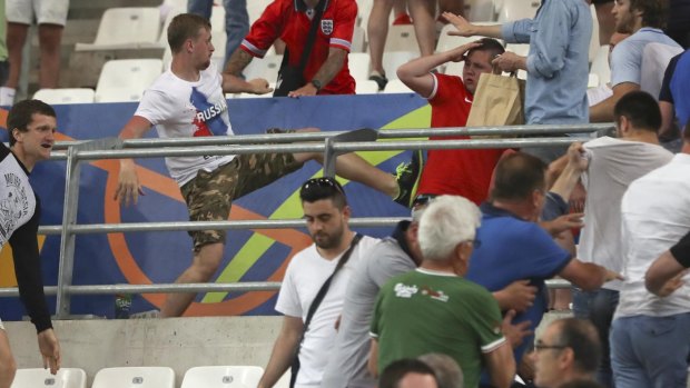 Clashes break out in the stands during the Euro 2016 Group B soccer match between England and Russia.