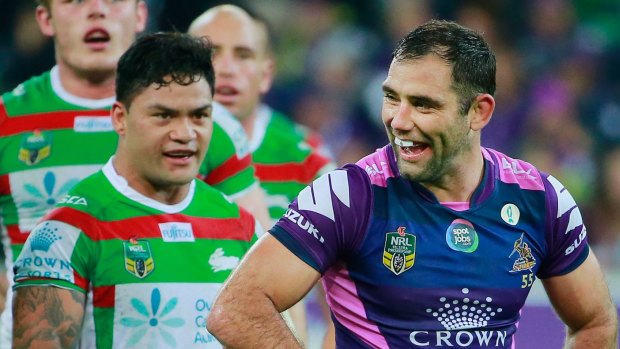 Happy days: Cameron Smith laughs as Issac Luke of the Rabbitohs looks on shortly after Smith kicked Luke in a tackle.