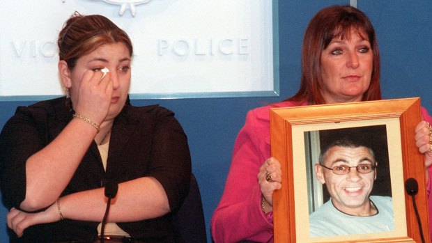 Victor Pierce's daughter Katie with her mother Wendy, holding a picture of her murdered husband.