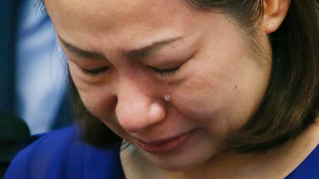 Choi Kyung-jin, the widow of South Korean businessman Jee Ick-joo, cries at the start of the Philippine Senate probe into the killing in Pasay City on Thursday.