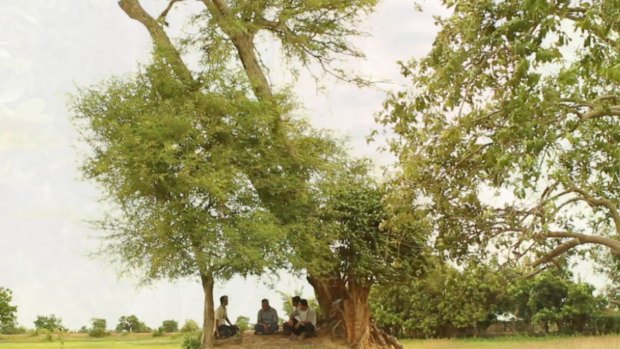 Bunhom Chhorn and his childhood friend sit under the tamarind tree in Camp 32 talking about what they saw there 40 years ago.