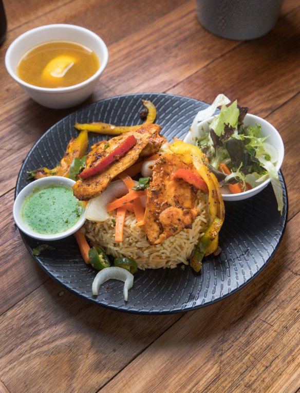 Chicken and pilaf, with a bowl of broth.