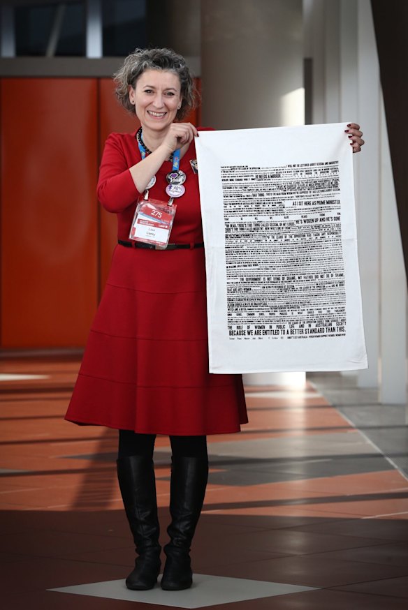Lisa Carey, Emily's List national co-ordinator, holding one of the tea towels, says the group wants everyone to remember the speech "whatever they're doing".