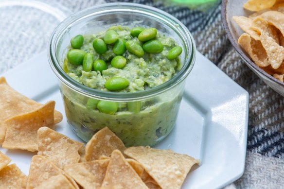 Avocado and edamame dip with tortilla chips.