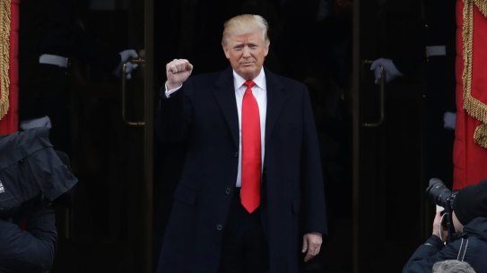 President-elect Donald Trump pumps his fist as he arrives for his Presidential Inauguration at the U.S. Capitol in Washington, Friday, Jan. 20, 2017. (AP Photo/Patrick Semansky)