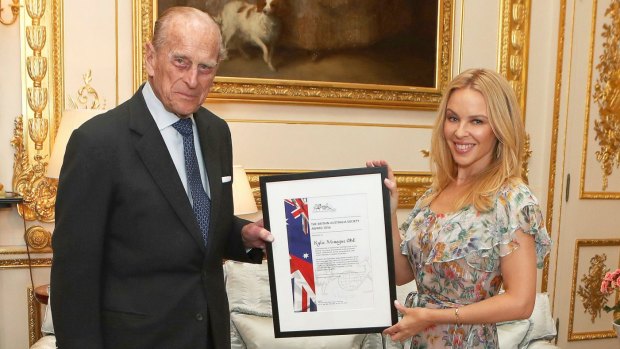 Prince Philip presents Kylie Minogue with the Britain-Australia Society Award.