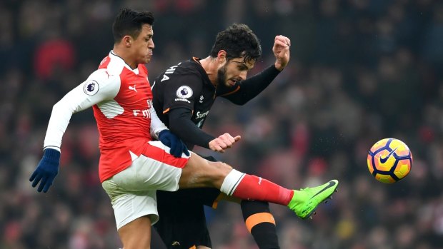 Hull's Andrea Ranocchia and Arsenal's match-winner Alexis Sanchez compete for the ball.