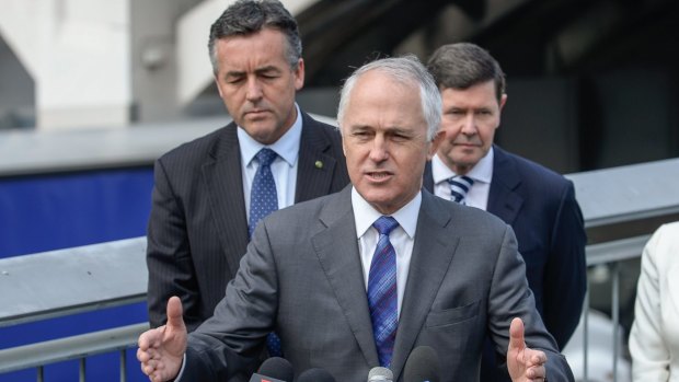 Prime Minister Malcolm Turnbull flanked by former Abbott ministers Darren Chester and Kevin Andrews.