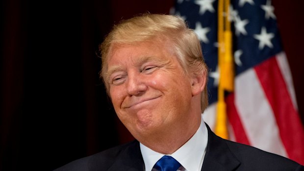 Republican presidential candidate Donald Trump smiles while speaking at a rally at Drake University in Des Moines, Iowa.