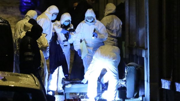 Investigators at the scene where two men were killed in an anti-terror raid in Belgium in January.