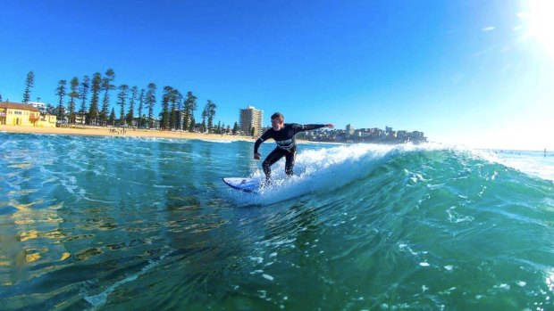 NSW Premier Mike Baird, in a photo from his Facebook page, rides the waves. 