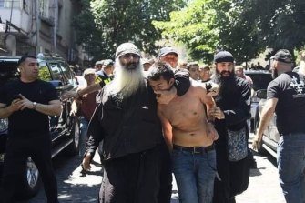 The photograph published by Open Caucasus Media that the organisation says shows an orthodox priest in Tbilisi dragging away a local journalist whose shirt has been torn off. 