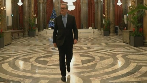 The High Commissioner, Alexander Downer, strolling through Australia House.