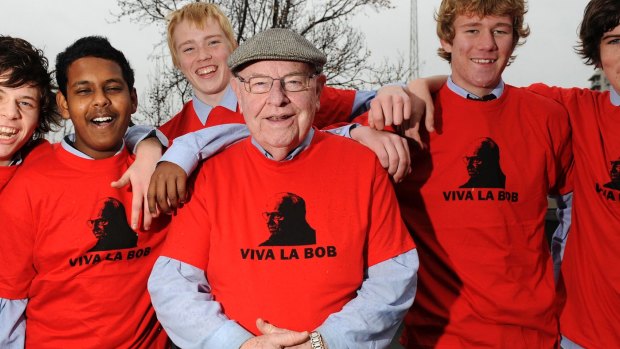 Father Bob with students modelling his T-shirts for a Sunday Run Melbourne, a fundraiser, in 2010.