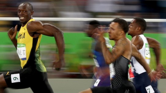 Smile for the camera: Usain Bolt competes in the men's 100m semi-final.