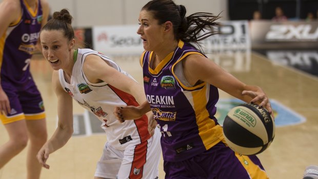 Boomer Alice Kunek (right) drives hard to the basket.