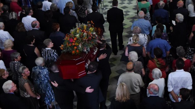 The casket of Faith Bandler arrives in The Great Hall at Sydney University.