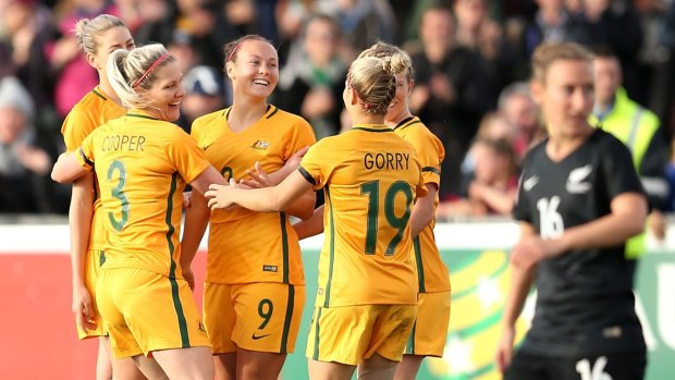 Caitlin Foord celebrates a goal with Matildas teammates.