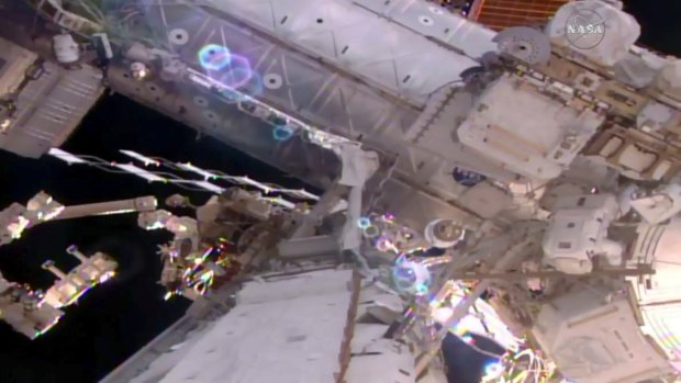Astronaut Shane Kimbrough (bottom right) works on the International Space Station during a spacewalk on Friday.