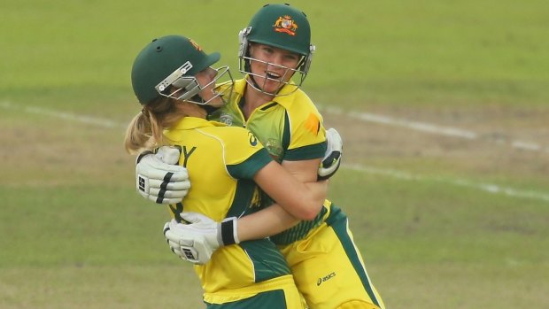Jess Cameron (right) with Ellyse Perry after winning the women's World Twenty20 title in 2014.