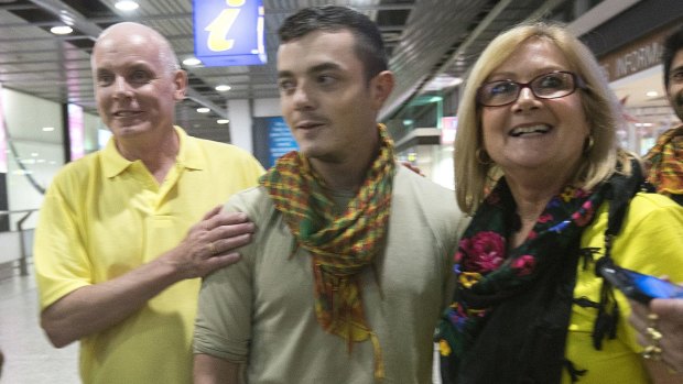 Scott and Julia Dyball greet their son Ashley who returned to Melbourne after fighting Islamic State.