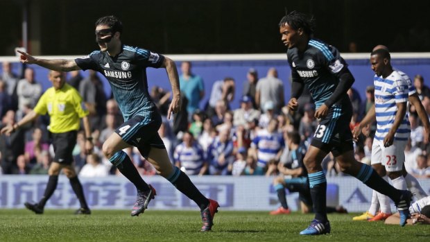 Chelsea's Cesc Fabregas celebrates after scoring a late goal to beat QPR at Loftus Road on Sunday.