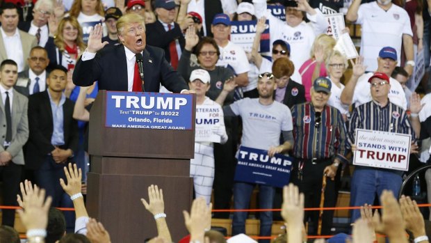 Republican presidential candidate Donald Trump speaks to the crowd asking them to take a pledge to promise to vote for him during a campaign rally in Orlando, Florida.