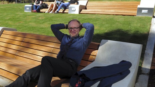 The University of Canberra's Vice-Chancellor Stephen Parker relaxes on the newly landscaped concourse. 

