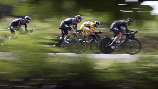Chris Froome, in the race leader's yellow jersey, zips along in the team time trial on Sunday.