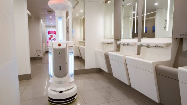 A cleaning robot in an airport bathroom. 