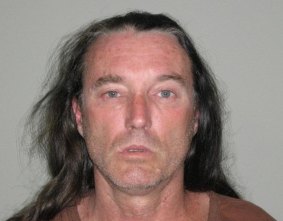 Police are searching for David Charles Brown, 50, over an alleged stabbing attack in Helensvale.