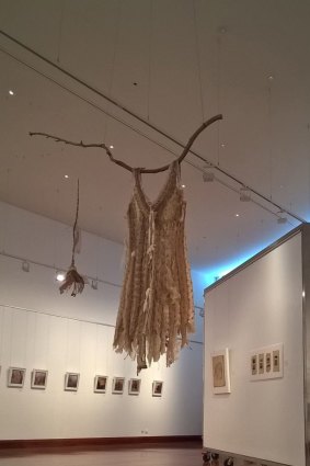 A dress, made from snake skins, hangs in the centre of the exhibition.