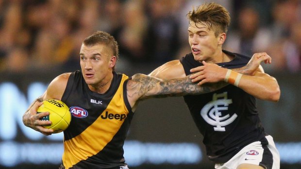 Dustin Martin shrugs off Patrick Cripps during the Tigers' round one win.